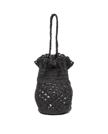 The Crochet Drawstring Bag by THE GREAT. SU23 is a black cylindrical crocheted bag with a braided strap, crafted from Agave plant fibers and featuring a decorative pattern.