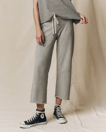 Someone rocks a THE GREAT. CORE KNITS Varsity Grey Wide Leg Cropped Sweatpant, perfectly paired with black high-top sneakers.