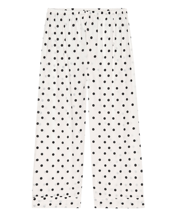 Laid flat, these cream polka dot Easy Sleep Pants by THE GREAT. PS25 SLEEP feature an elastic waistband and straight legs, blending style and comfort for your ideal sleepwear choice.
