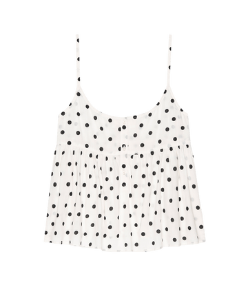 The Nighttime Cami by THE GREAT. PS25 SLEEP is a cream, sleeveless cami with black polka dots, thin straps, and a pleated design.
