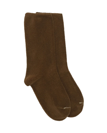 A pair of The Microterry Sock in bronze from THE GREAT. SU23 MICROTERRY, showcasing a 1970’s-inspired design, set against a white background.