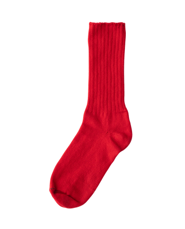 A single bright red sock with a ribbed texture from THE GREAT. HOL 22 D2 CASHMERE, crafted from a luxurious cashmere wool blend, set against a plain white background. Ideal for holiday gift sets.