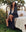 Wrapped comfortably in The Robe from THE GREAT. PS25 SLEEP, featuring a black mixed polka dot design, a person relaxes on an outdoor bed with a teddy bear, surrounded by plants and trees.