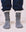 Showcasing style with The Sweatshirt Sock in Navy Blue, a person pairs these with sweatpants, creating the perfect look against a light fabric surface.